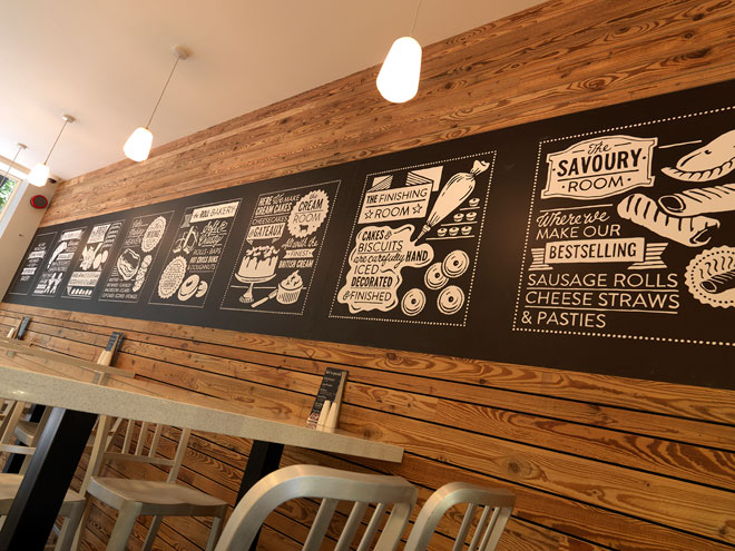 Decorative black boards in the seating area describe the business and the food Black boards in the seating area